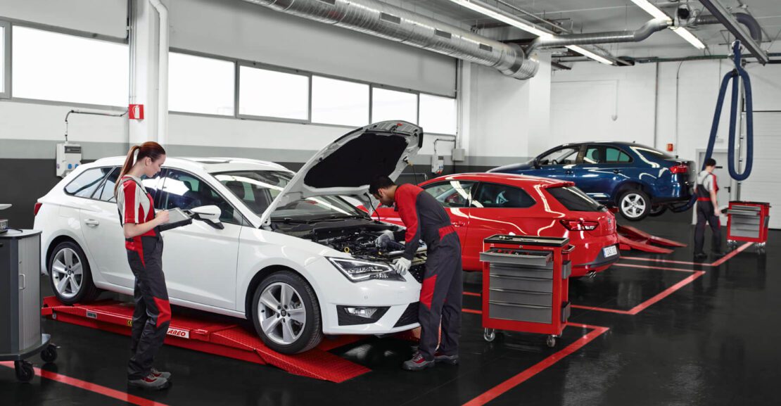 Car maintenance and servicing – SEAT mechanics inspecting a ca